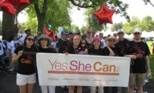 group holding Yes She Can banner