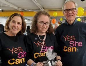 Marjorie Izzie and Paul wearing Yes She Can t-shirts